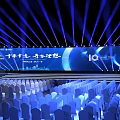 Large Event Venue With Blue Lighting Stage Backdrop Screen And Arranged Chairs