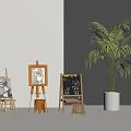 Sketching Art Supplies Display With Easels Drawing Boards Stools And Potted Palm Tree In White Gray Room