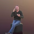 Man Sitting on Green Stool Talking on Phone Wearing Dark Sweater and Blue Jeans