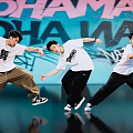 Men Dancing With Dynamic Moves In White T Shirts And Casual Pants Against Graffiti Wall