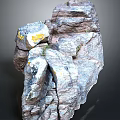 Natural Rock Formation With Detailed Surface Texture And Yellow Stains