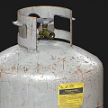 Old Rusty Metal Gas Cylinder With Valve And Yellow Warning Label