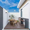 Serene Garden Entrance With White Walls Metal Slatted Gate Stone Paved Path And Green Plants