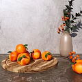Fresh Oranges on Wooden Tray with Gray Countertop and Vase with Orange Berries