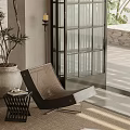Woven Outdoor Patio Chair With Side Table And Potted Plant
