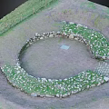 Circular Stone Garden Ornament with Grass Covered Edges and Central Square Slab