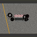 Red And White Striped Road Barricade With Black Danger Barrels And Tires