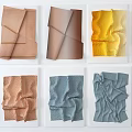 Unique Colorful Fabric Folded Textured Wall Decor Arranged On White Background