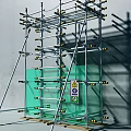 Construction Scaffolding Structure With Metal Support Frames Green Glass Panel And Safety Sign