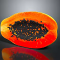 Fresh Sliced Papaya with Orange Flesh and Black Seeds on Dark Background