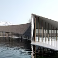 Modern Waterfront Building With Curved Roof And Columns And Snowy Water Reflection