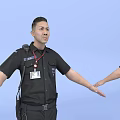 Man in Black Security Uniform With Badge Radio and Equipment Belt Front and Back Views
