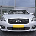 Silver Infiniti Sedan With Sleek Front Design Headlights And Grille In Outdoor Setting