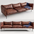Distressed Brown Leather Three Seater Sofa With Blue Blanket And Metal Legs