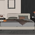 Modern Elegant Beige Double Bed Setup With Pillows Brown Blanket Nightstand Lamp And Wall Mirror