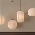 Four Hanging Round Cream Colored Paper Lanterns With Light Wall And Wooden Surface