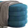 Multicolored Stacked Round Ottomans in Orange Blue Green with Soft Gray Blanket