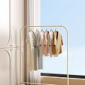 Stylish Clothes Hanging On Golden Rack With Bright Window And White Cabinet