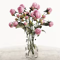 Clear Glass Vase with Pink Roses and Green Leaves on Light Colored Surface