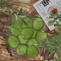 Ceramic Nut Jar with Green Apples Olive Branches and Plants on Wooden Table