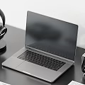 Sleek Laptop On Black Desk With Headphones Notebooks Smartphone Clock And Mouse