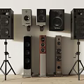 Various Styles of Audio Speakers Including Floor Standing and Bookshelf in Different Colors on Stands