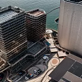 Modern Tall Buildings With Glass Facades And Ocean View At Sunset