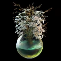 Green Glass Vase With White Small Flowers And Slender Branches On Black Background