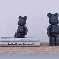 Stylish Black Bear Decorative Ornament Set Placed On Books Over Wooden Table