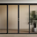 Black Framed Sliding Doors with Vertical Glass Slats in Modern Interior and Potted Plant