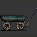 Blue Vintage Wheelbarrow with Four Rustic Wheels on Brown Mat Against Dark Background