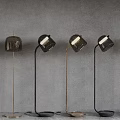 Modern Floor Lamps With Glass Shades And Metal Frames Against Grey Background
