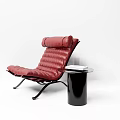 Modern Red Leather Lounge Chair With Black Side Table And Books
