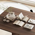 Decorative Accessories Set with White Vase Green Foliage Open Books Teacups on Wooden Coffee Table