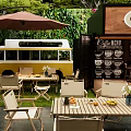 Commercial Coffee Shop Equipment Featuring Bar Counter Outdoor Tables And Green Plants