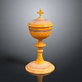 Yellow Carved Sculpture Vessel With Intricate Patterns And Cross Topped Lid On Pedestal Base