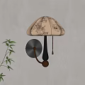 Beige Patterned Shade Wall Lamp With Black Gold Body On Light Wall And Green Plant