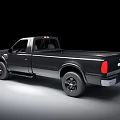 Dark Colored Single Cab Pickup Truck With Silver Accents And Large Wheels