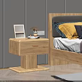 Wooden Bedside Table Next to Bed With Photo Frame Dried Flowers And Mug On Top