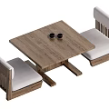 Wooden Square Tea Table And Chairs With Light Cushions And Two Black Cups