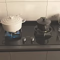 Kitchen Appliances Black Gas Stove With Two White And Black Pots Stacked Glass Cups