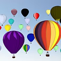 Colorful Vibrant Fun Outdoor Amusement Rides With Hot Air Balloons Flying in Clear Sky