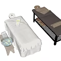 Comfortable Massage Tables with White Sheets Tray Bowl Dark Surface Brown Pillows and Black Frame