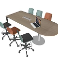 Wooden Conference Table With Laptop Keyboard And Colorful Chairs In Office