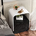 White and Black Modern Nightstand With Flower Vase Cookies Candle and Book