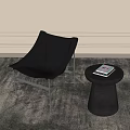 Gray Leather Lounge Chair With Round Side Table And Magazine On Gray Rug