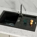 Black Kitchen Sink With Faucet Water Dripping Draining Board And Vegetables On Marble Countertop
