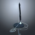 Black pen with white cord on black base and blue light reflection in gray gradient