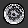 Shiny Black Tire With Modern Silver Alloy Rim And Intricate Spoke Pattern
