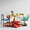 Colorful Dining Table With Transparent And Colored Chairs Flower Arrangement And Fruits On Colorful Rug